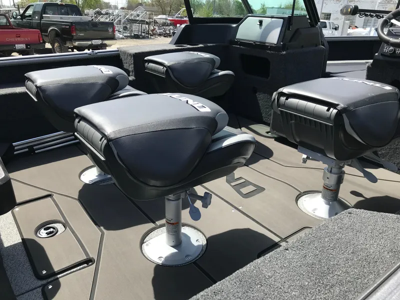 Slide: The Image of 2025 Lund 1875 Impact XS Sport boat interior with four cushioned seats. - 24
