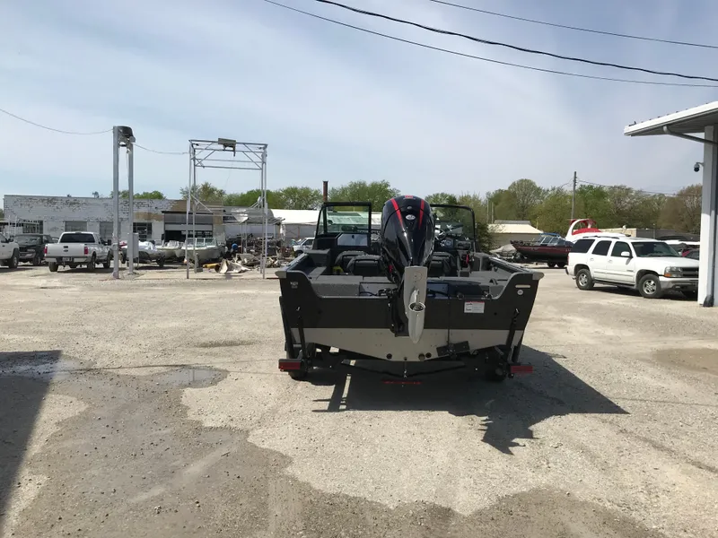 Slide: The Image of 2025 Lund 1875 Impact XS Sport boat parked in a lot, rear view. - 7