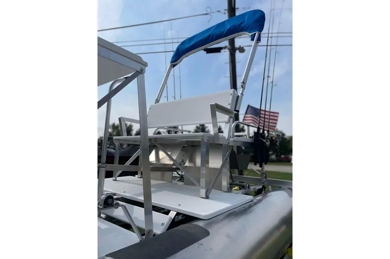 Slide: The Image of 2023 Aqua Cycle AC15 pontoon boat with blue canopy and American flag in background. - 11