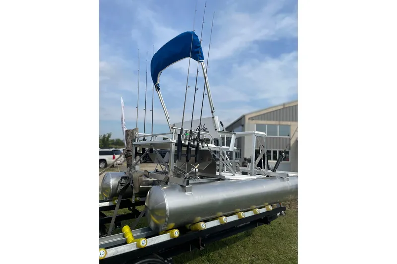 Slide: The Image of Aqua Cycle AC15 pontoon boat with blue canopy, 2023 model, displayed outdoors. - 7