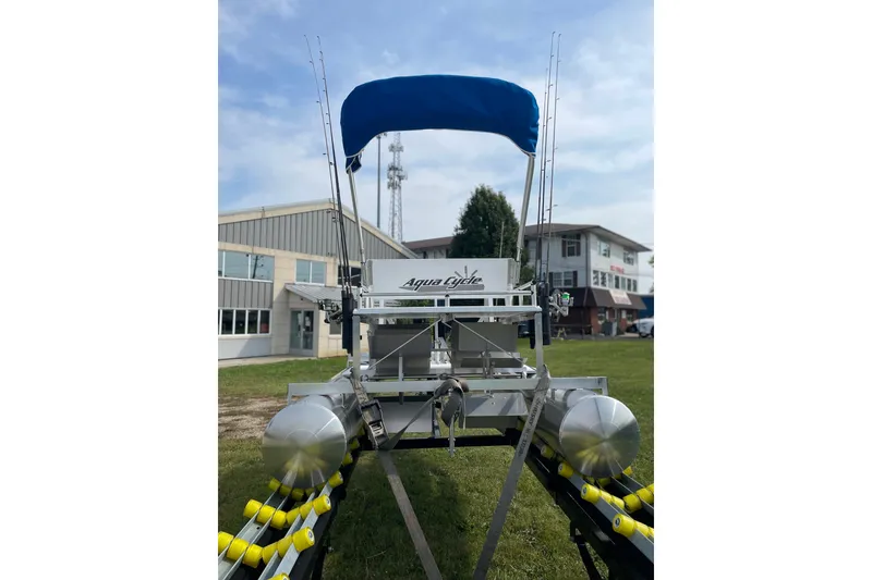 Slide: The Image of 2023 Aqua Cycle AC15 pontoon boat with blue canopy, parked on grass. - 8