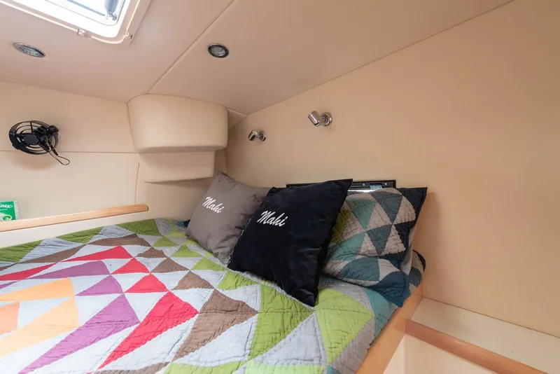 Slide: The Image of Cozy cabin interior of 2017 Balance 451 with colorful geometric quilt and pillows. - 24