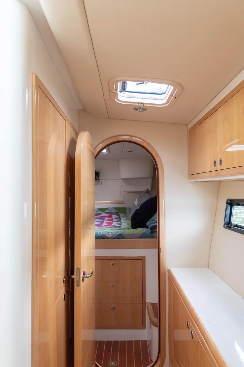 Slide: The Image of Interior of a 2017 Balance 451 yacht, featuring wooden cabinetry and a cozy sleeping area. - 25