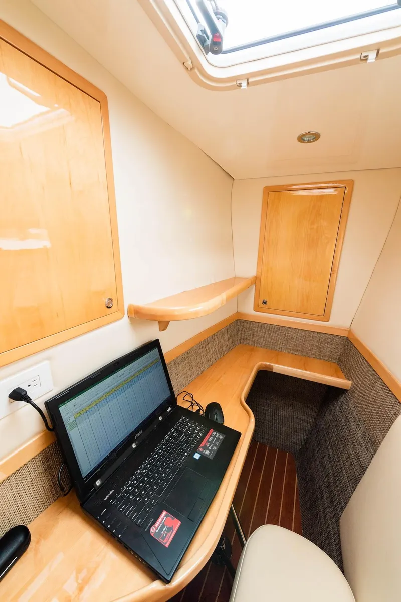 Slide: The Image of Compact workspace on a 2017 Balance 451 yacht with laptop and wooden cabinetry. - 26