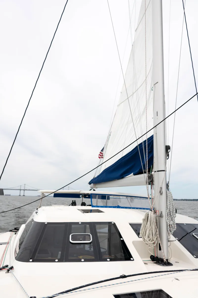 Slide: The Image of Sailing catamaran Balance 451, 2017 model, with white sails on open water. - 9