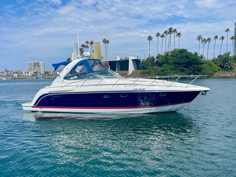 Slide: The Image of 2004 Formula 37 PC yacht cruising on a sunny day near palm trees and cityscape. - 0