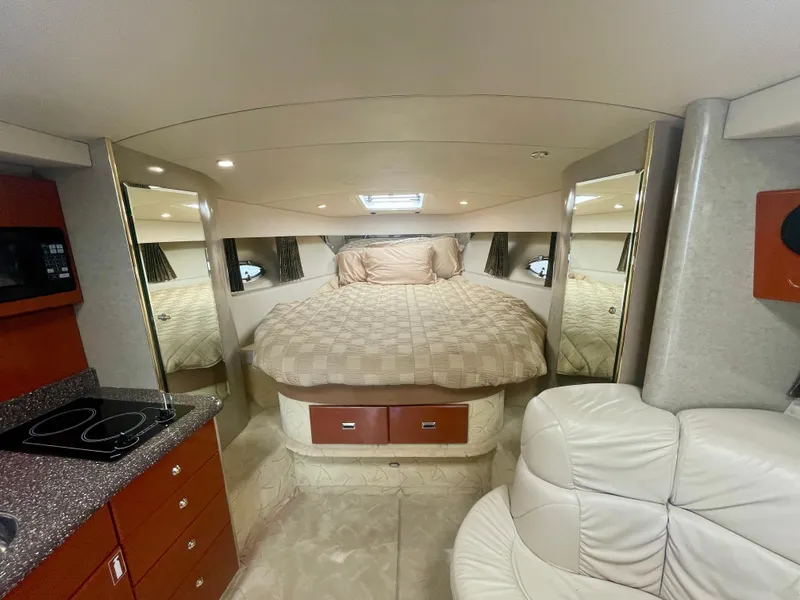 Slide: The Image of Interior of 2004 Formula 37 PC yacht with bed, kitchenette, and seating area. - 12