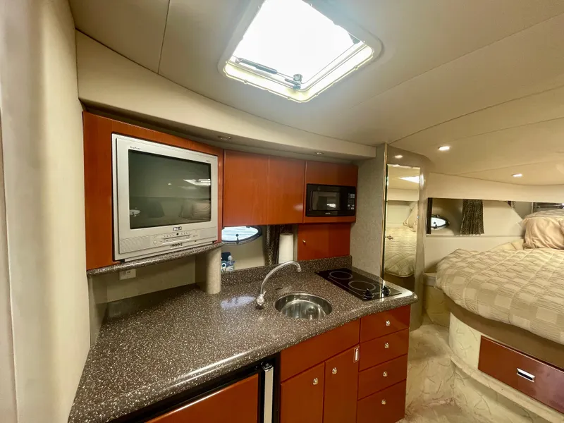 Slide: The Image of 2004 Formula 37 PC yacht interior with kitchenette, TV, and cozy sleeping area. - 13
