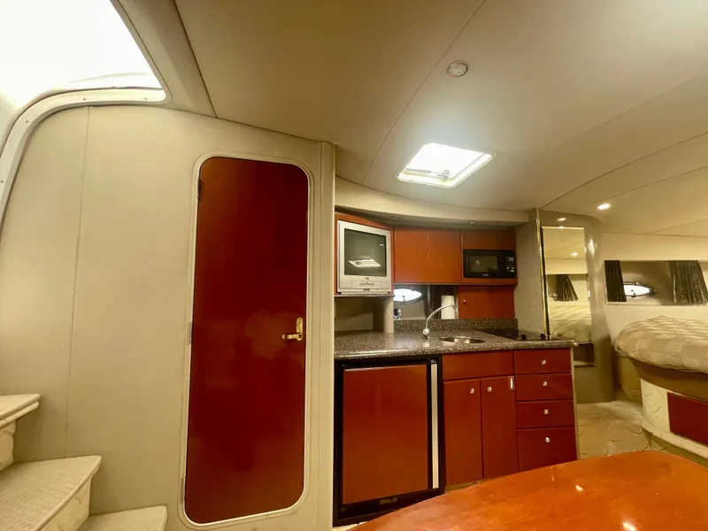 Slide: The Image of 2004 Formula 37 PC yacht interior with kitchenette, wood cabinetry, and modern appliances. - 15