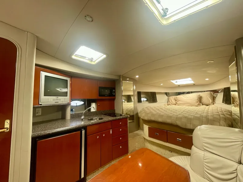 Slide: The Image of 2004 Formula 37 PC yacht interior with kitchenette, bed, and seating area. - 16