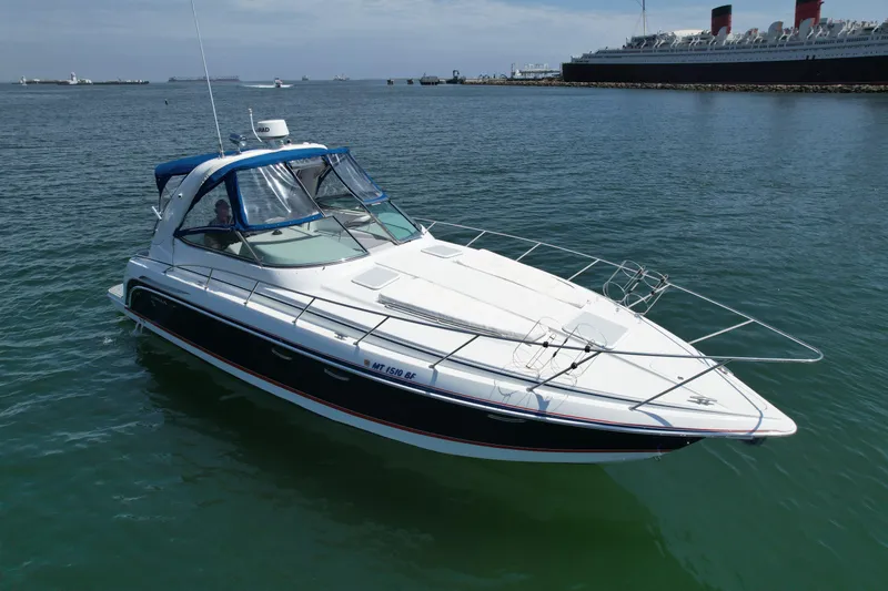 Slide: The Image of 2004 Formula 37 PC yacht cruising in open water near a harbor. - 2