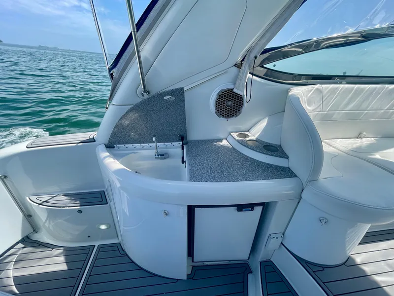 Slide: The Image of 2004 Formula 37 PC yacht interior with sleek seating and compact kitchenette by the sea. - 26