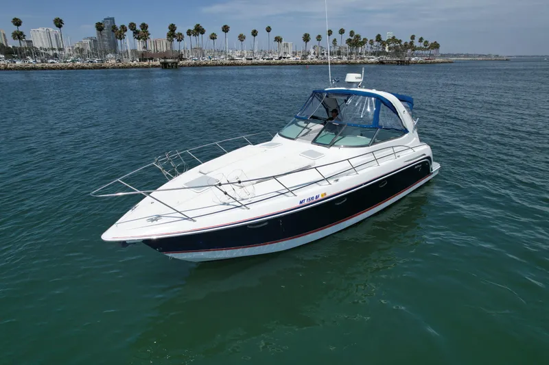 Slide: The Image of 2004 Formula 37 PC yacht cruising on calm waters near a marina with palm trees. - 3