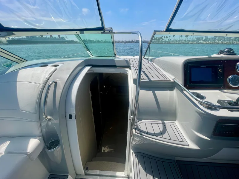 Slide: The Image of 2004 Formula 37 PC yacht interior with open cabin door, sleek dashboard, and ocean view. - 30