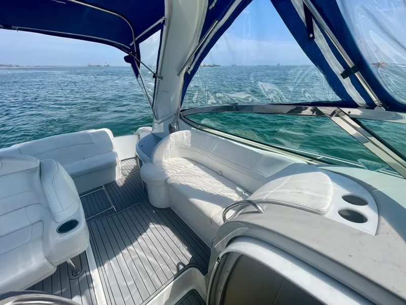 Slide: The Image of 2004 Formula 37 PC yacht interior with white seating, blue canopy, and ocean view. - 35