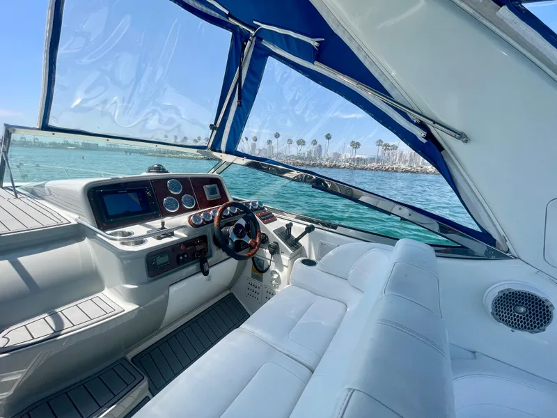 Slide: The Image of 2004 Formula 37 PC yacht cockpit with steering wheel, dashboard, and ocean view. - 36