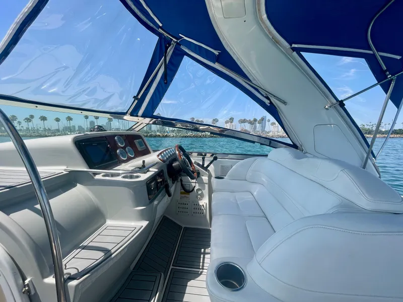 Slide: The Image of 2004 Formula 37 PC yacht interior with blue canopy, white seating, and ocean view. - 37