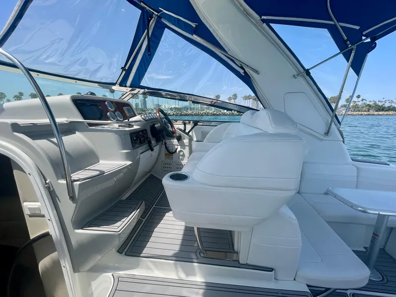 Slide: The Image of 2004 Formula 37 PC yacht interior with white seating and blue canopy on a sunny day. - 39