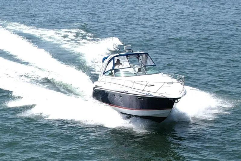 Slide: The Image of 2004 Formula 37 PC boat cruising on open water, creating a wake. - 4