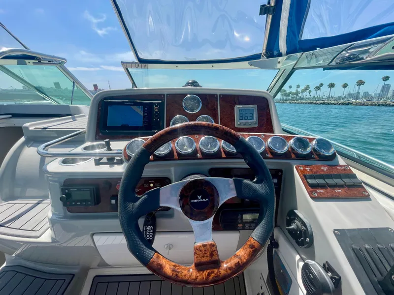 Slide: The Image of Steering wheel and dashboard of a 2004 Formula 37 PC boat on a sunny day. - 41
