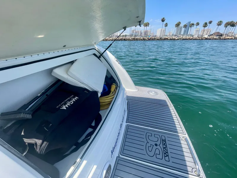 Slide: The Image of 2004 Formula 37 PC boat with open storage, docked near palm trees and calm water. - 47