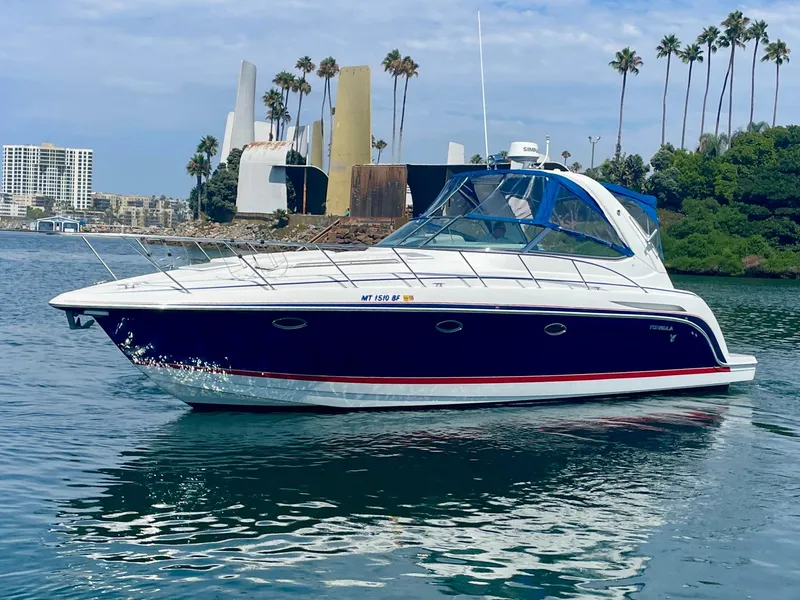 Slide: The Image of 2004 Formula 37 PC yacht cruising on calm waters near a scenic shoreline. - 8