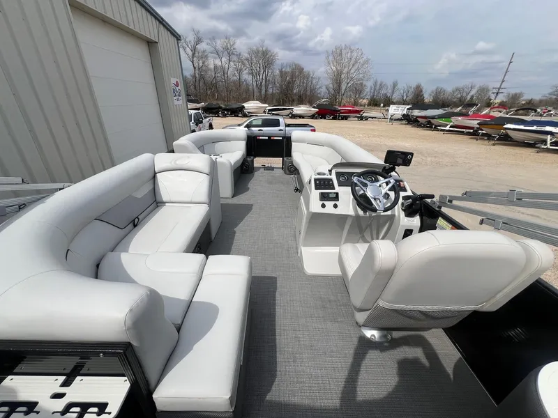 Slide: The Image of 2022 Crest Classic Fish 200 pontoon boat with spacious seating and modern helm. - 10