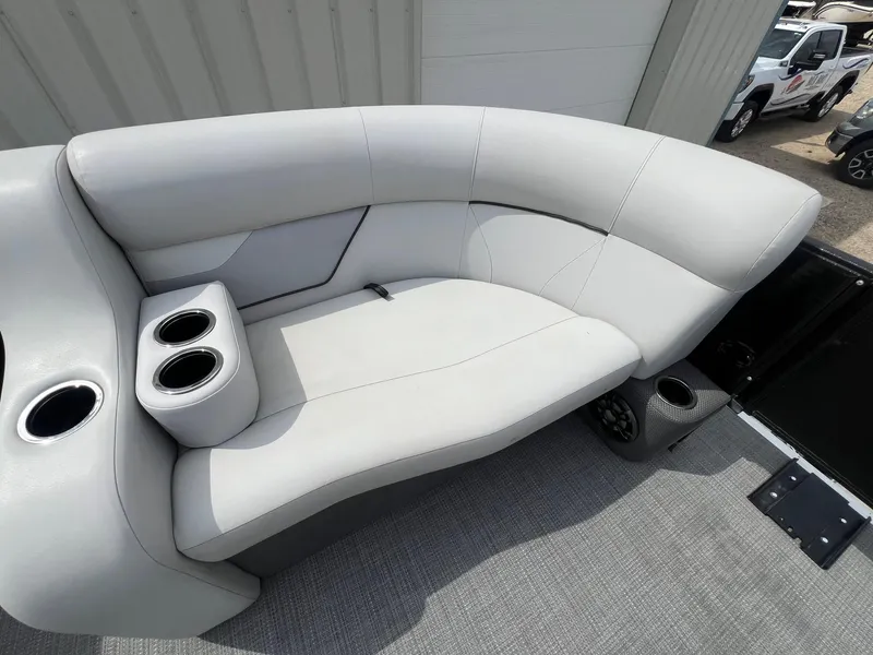 Slide: The Image of 2022 Crest Classic Fish 200 boat seating with cup holders, gray upholstery, and modern design. - 11