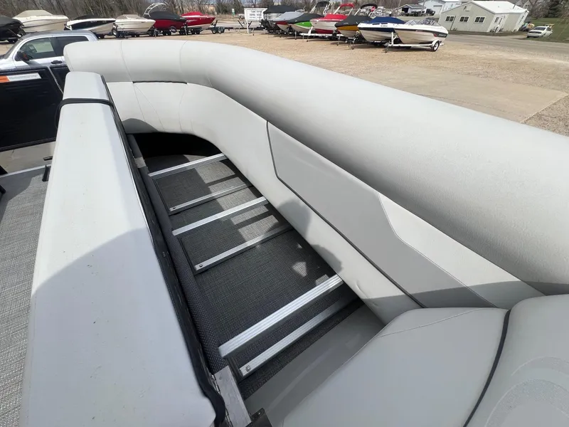 Slide: The Image of 2022 Crest Classic Fish 200 boat interior with gray seating and storage area. - 15