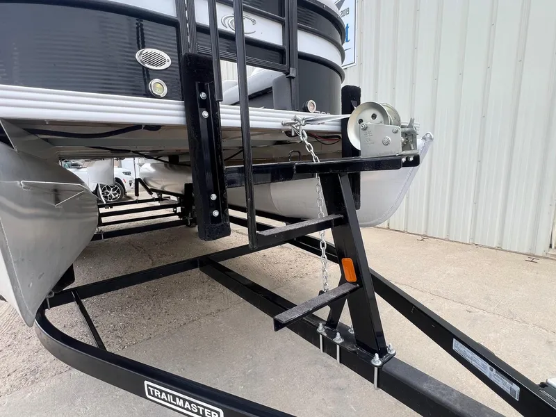 Slide: The Image of 2022 Crest Classic Fish 200 boat on a Trailmaster trailer, parked outside a building. - 25