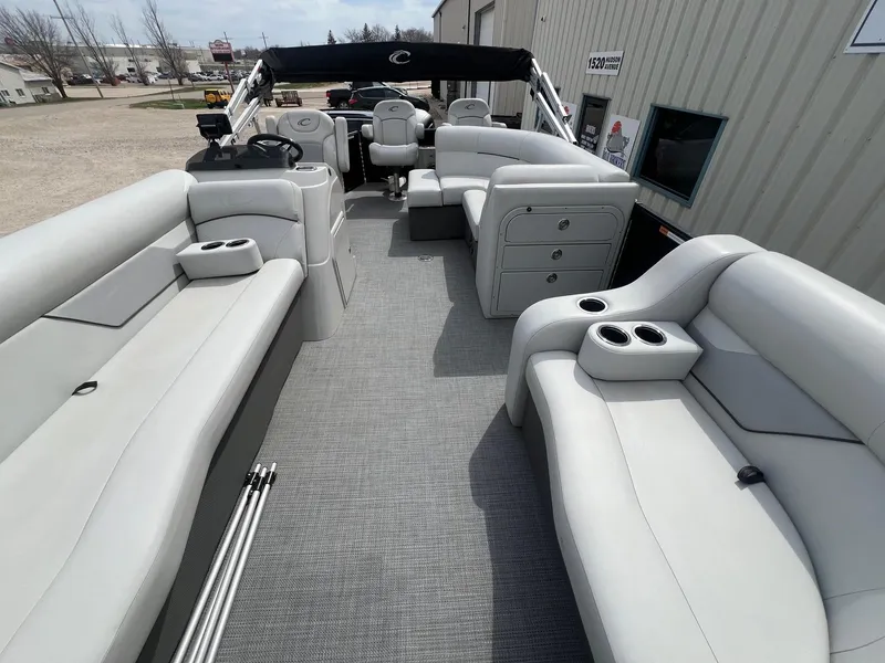 Slide: The Image of 2022 Crest Classic Fish 200 pontoon boat interior with spacious seating and cup holders. - 6