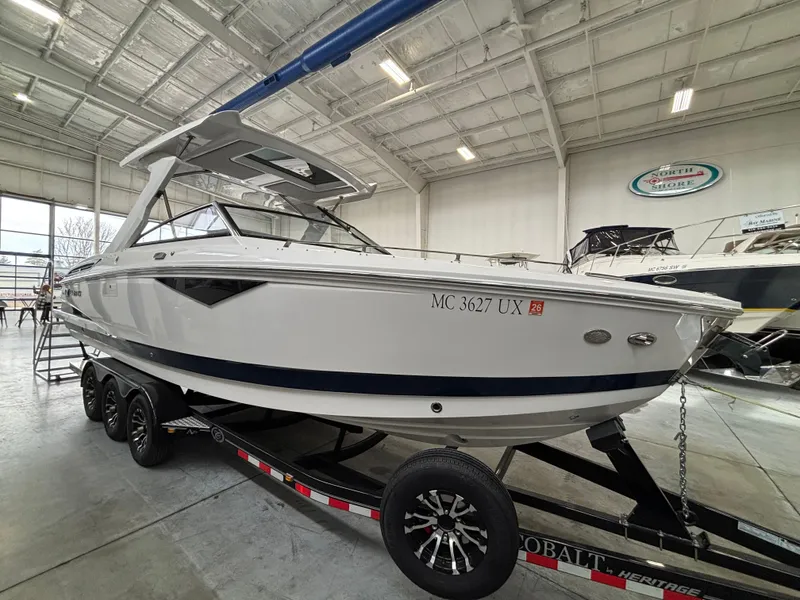 Slide: The Image of 2022 Cobalt A29 boat on trailer in indoor showroom. - 1