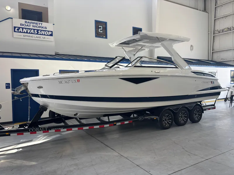 Slide: The Image of 2022 Cobalt A29 boat on trailer in indoor showroom. - 2