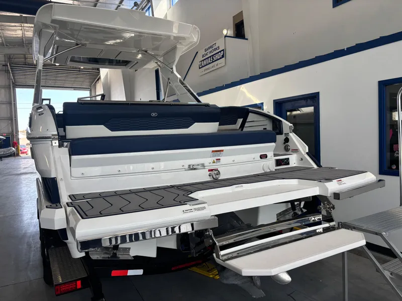 Slide: The Image of 2022 Cobalt A29 boat in showroom, featuring swim platform and sleek design. - 3