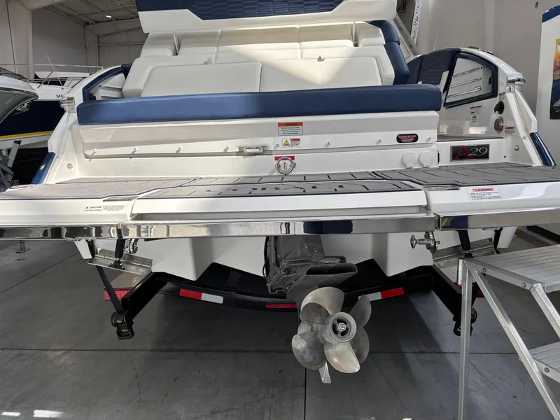 Slide: The Image of 2022 Cobalt A29 boat rear view with swim platform and propeller in showroom. - 4