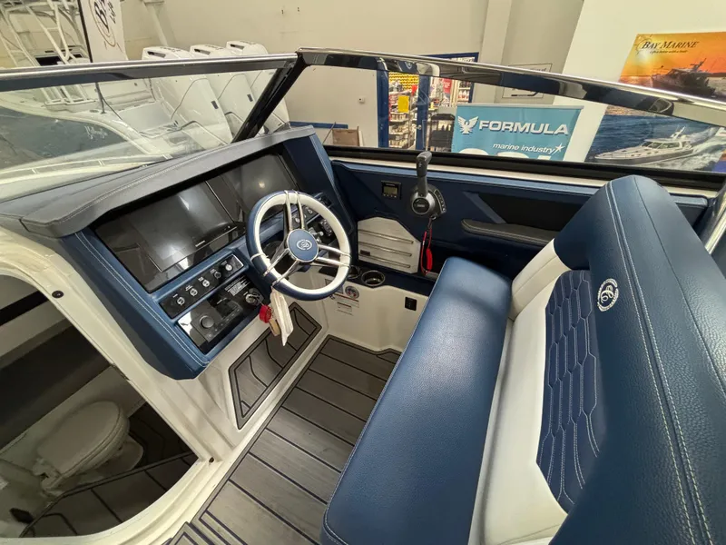 Slide: The Image of Interior of a 2022 Cobalt A29 boat with blue seating and modern dashboard. - 5