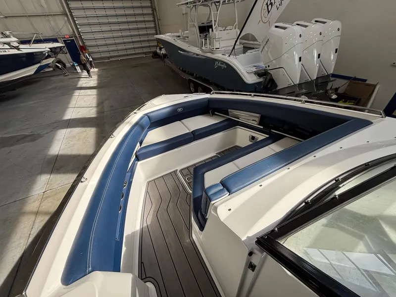 Slide: The Image of 2022 Cobalt A29 boat interior with blue seating in a showroom. - 6