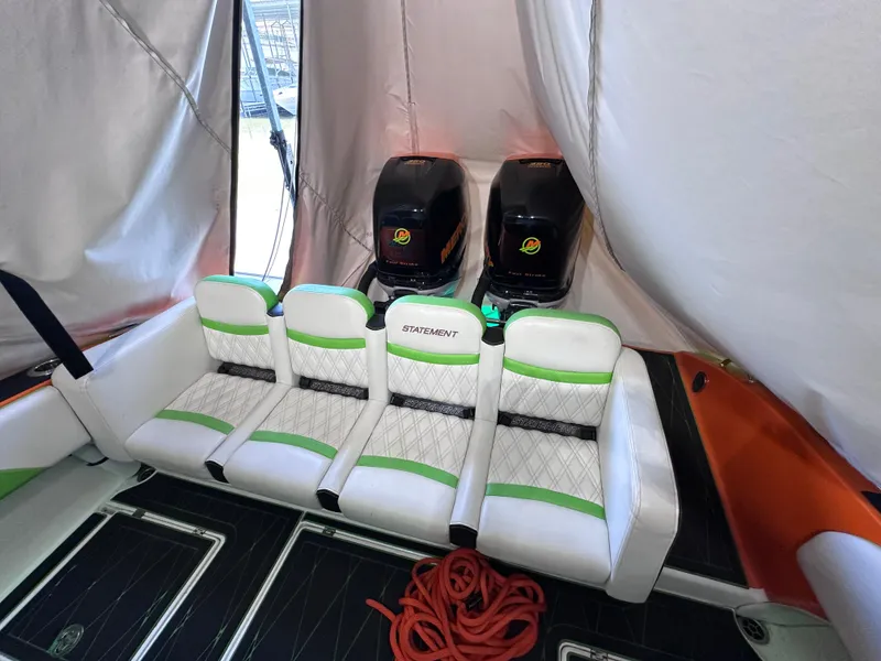 Slide: The Image of 2017 Statement 350 Open boat interior with white and green seating, dual engines, and red rope. - 13