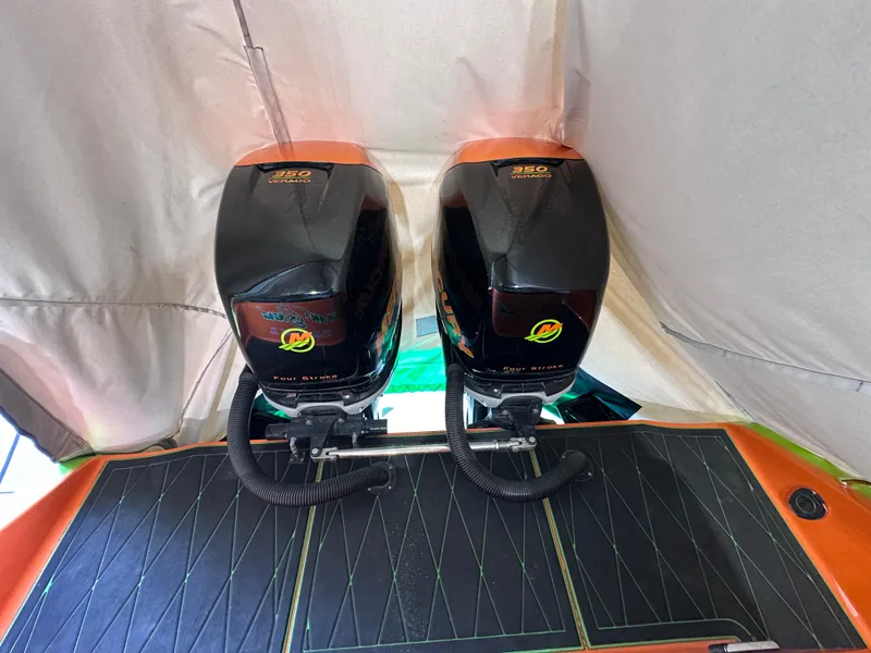 Slide: The Image of Twin outboard motors on a 2017 Statement 350 Open boat, under a protective cover. - 17