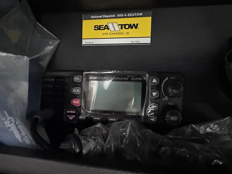 Slide: The Image of VHF radio and Sea Tow card in a 2017 Statement 350 Open boat. - 19