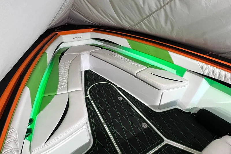 Slide: The Image of Interior of 2017 Statement 350 Open boat with white seating and green ambient lighting. - 24