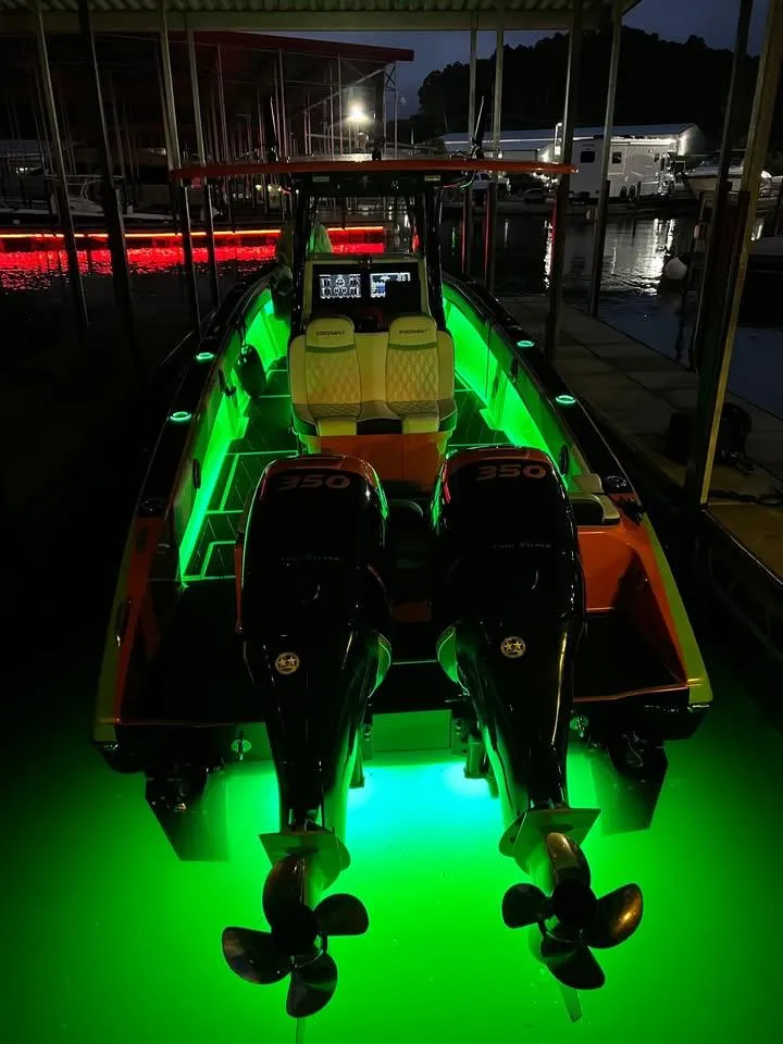 Slide: The Image of 2017 Statement 350 Open boat with illuminated green underwater lights at night. - 3