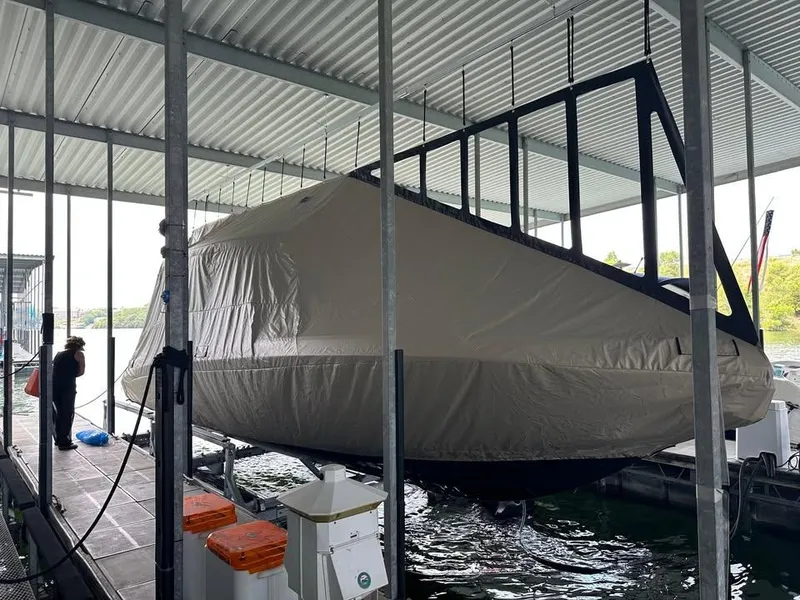 Slide: The Image of Covered 2017 Statement 350 Open boat docked under a metal roof. - 7