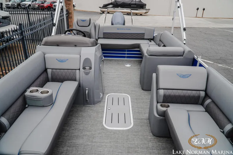 Slide: The Image of 2024 Bennington 23LSB pontoon boat interior with gray seating and cup holders at Lake Norman Marina. - 10