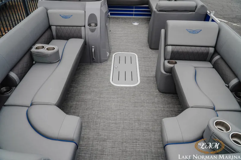 Slide: The Image of 2024 Bennington 23LSB pontoon boat interior with gray seating and cup holders. - 11