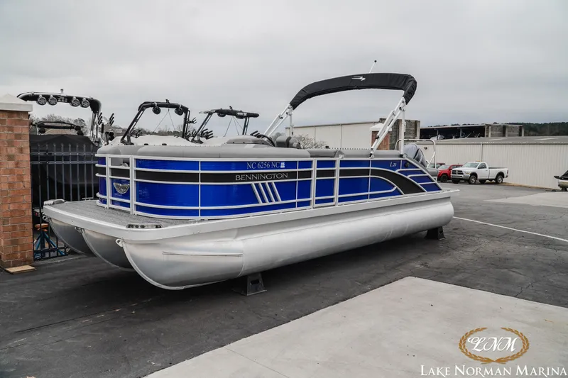 Slide: The Image of 2024 Bennington 23LSB pontoon boat in blue at Lake Norman Marina. - 2