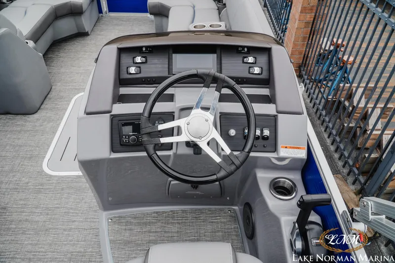 Slide: The Image of 2024 Bennington 23LSB boat helm with steering wheel and control panel at Lake Norman Marina. - 9