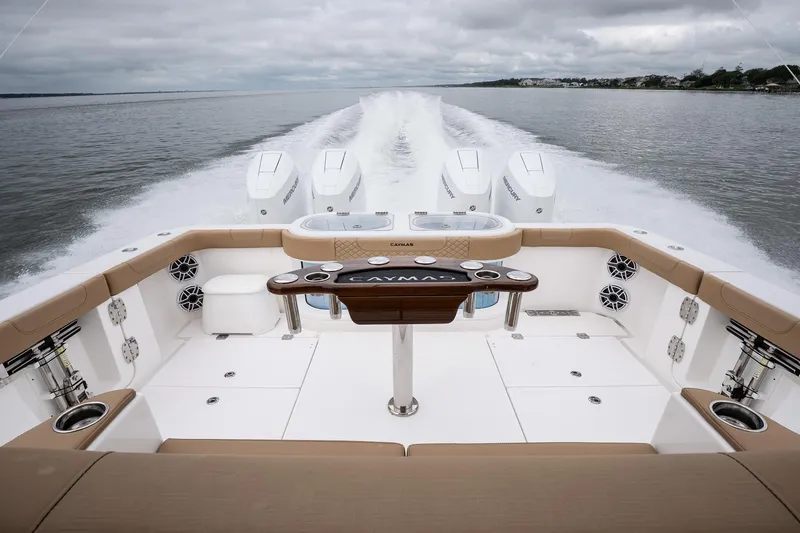 Slide: The Image of 2025 Caymas 44 CT boat cruising on open water, showcasing powerful engines and spacious deck. - 19