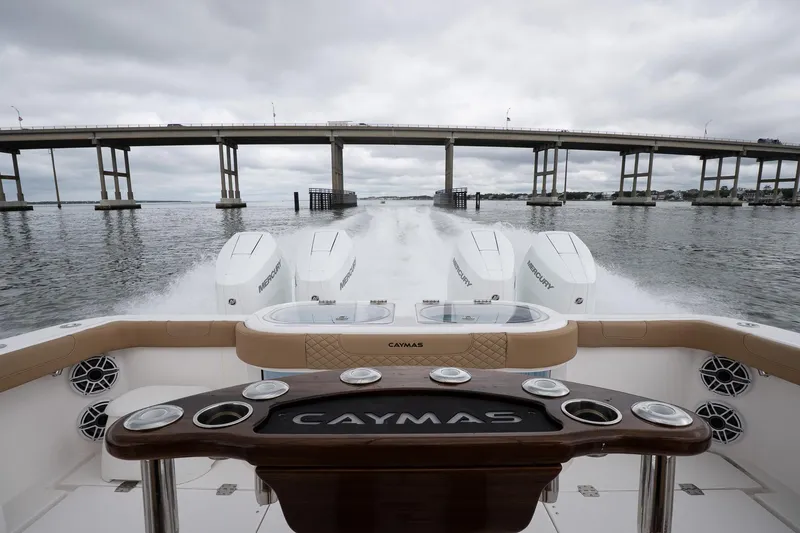 Slide: The Image of 2025 Caymas 44 CT boat cruising under a bridge on a cloudy day. - 29
