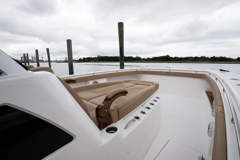 Slide: The Image of 2025 Caymas 44 CT boat with luxurious seating, docked by a serene waterfront. - 31